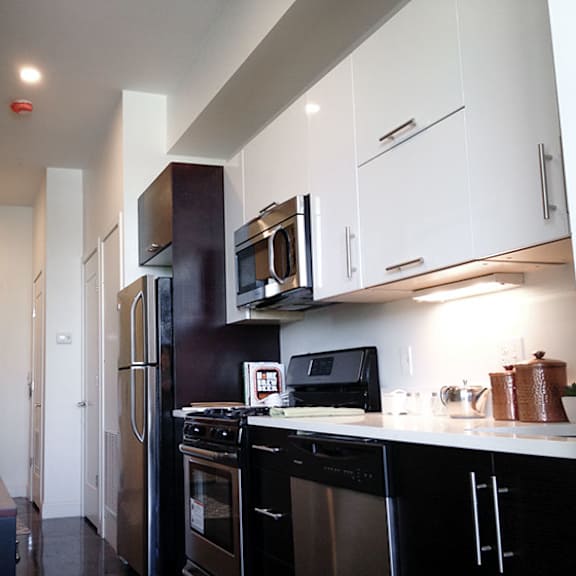 a kitchen with black appliances and white cabinets.